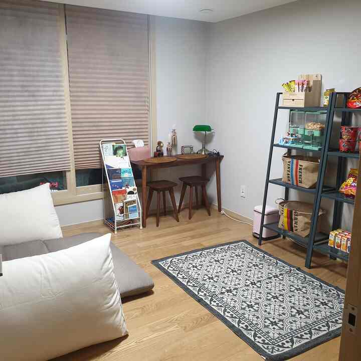 Natural-toned small room home cafe featuring wooden furniture and a patterned rug with cozy atmosphere