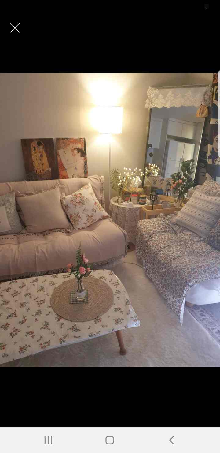 Beige and natural tone living room featuring floor lamp and fabric sofas with a cozy atmosphere