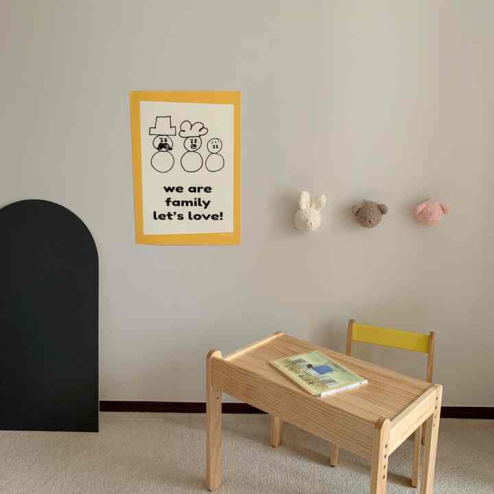 Simple kids' room with beige carpet, white walls, wood-tone desk, and yellow chair creating a warm atmosphere