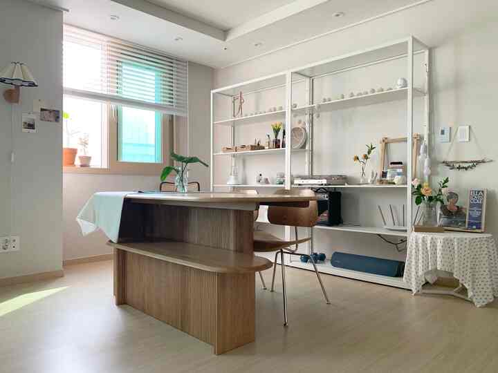 Natural wood tone and white dining room with simple modern style, well-lit by natural light