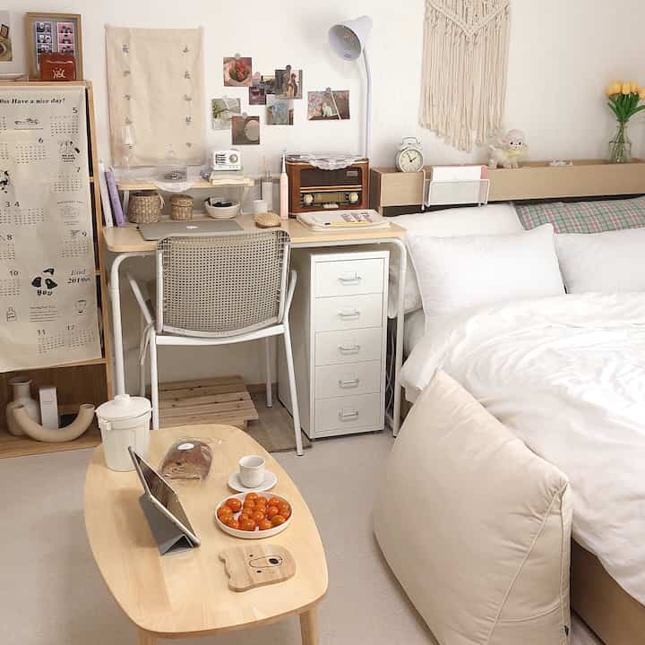 White and beige toned bedroom with desk area, showcasing a cozy natural modern interior space