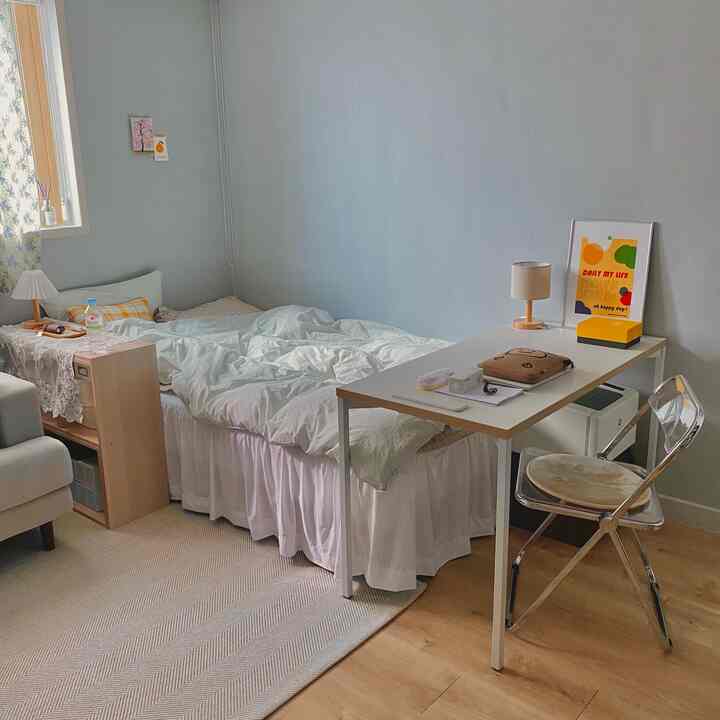 White and wood tone 6-tatami room featuring bed, desk, and transparent chair with clean bright atmosphere