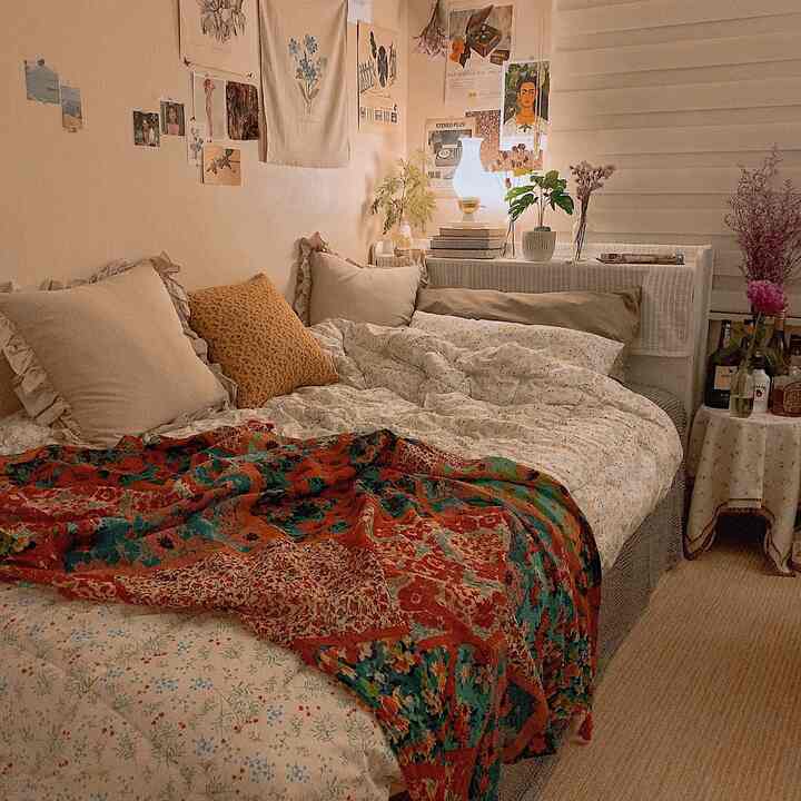 Warm beige natural-toned bedroom featuring cozy bedding and vintage posters creating a snug atmosphere
