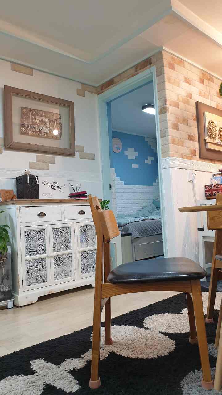 Natural color toned vintage living room featuring console table and wooden chairs with cozy cafe style