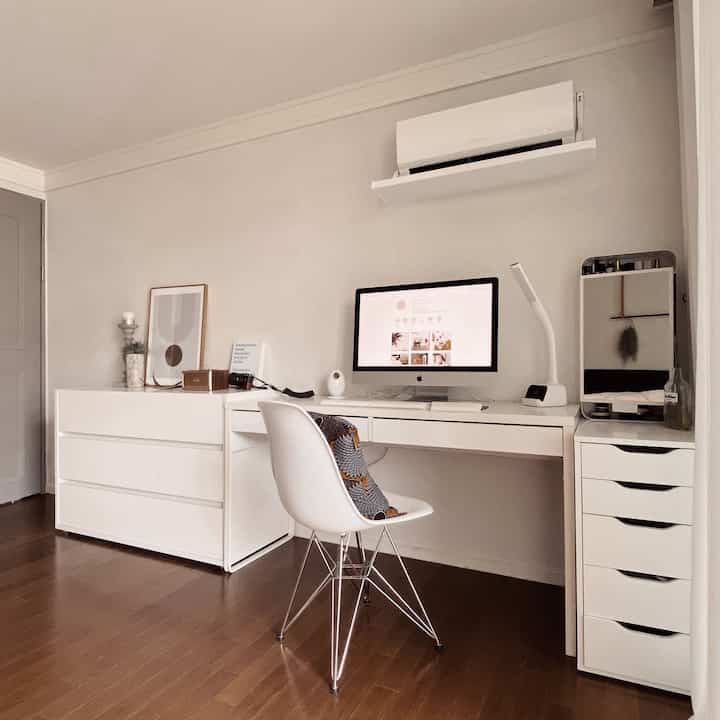 White and brown toned study with clean desk, drawer units, and chair arranged in a minimalistic space