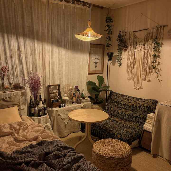 Cozy bedroom with natural tones featuring rattan lighting and vintage sofa