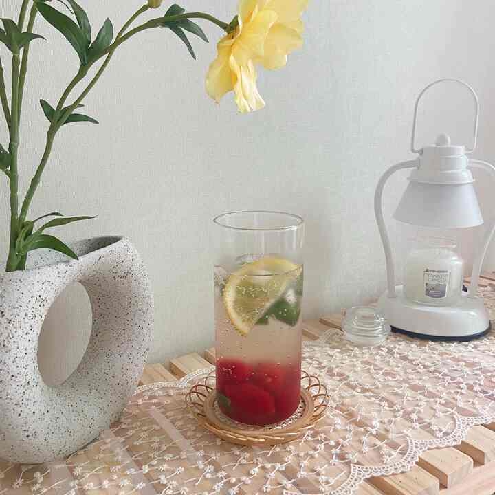 Natural wood shelf with lace table runner, vase with flower, and candle lamp creating a calm natural style space