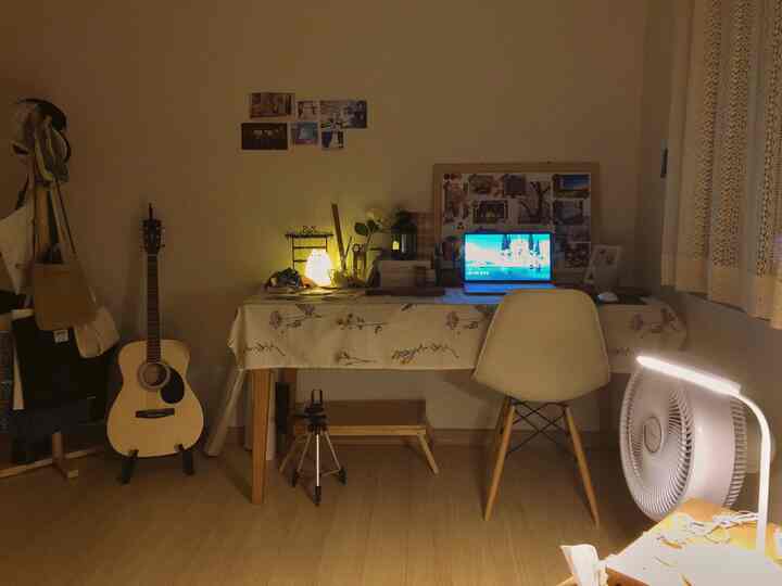 Ivory and wood-toned single household room featuring a floral table runner on desk and lace curtain, creating a vintage atmosphere