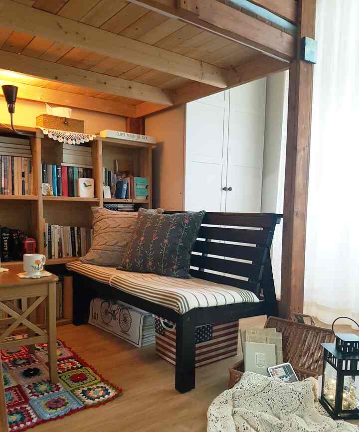 Warm wood-tone bunker-style home cafe featuring a bench with cushions and bookshelf, creating a cozy and inviting interior