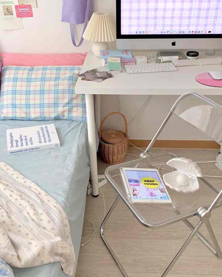 White and pastel toned compact single household bedroom with home office setup