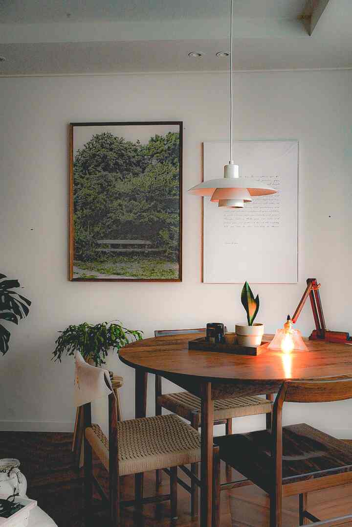 Natural-toned living room featuring a wooden dining table and pendant light creating a warm atmosphere