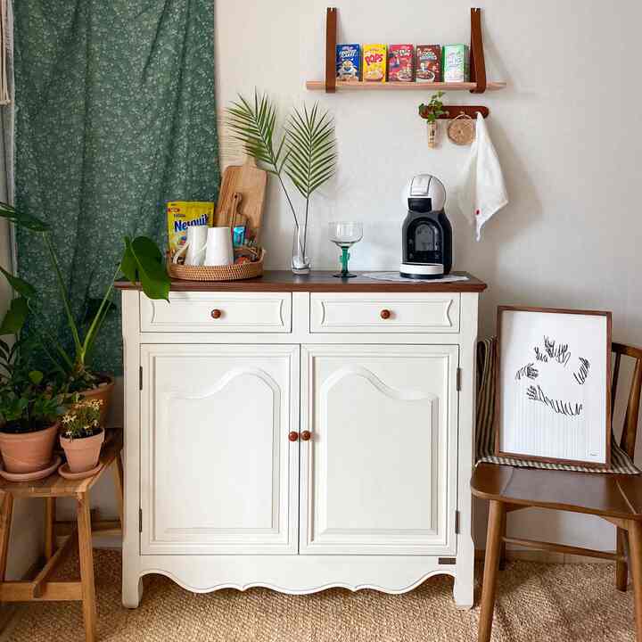 Cozy home cafe space with natural tones and wood elements, featuring wooden furniture and plants for a warm atmosphere