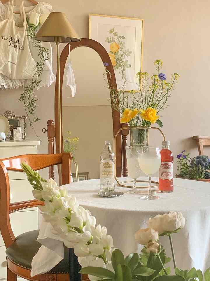 Vintage home cafe with white tablecloth, gold lighting, and wooden furniture creating a cozy atmosphere