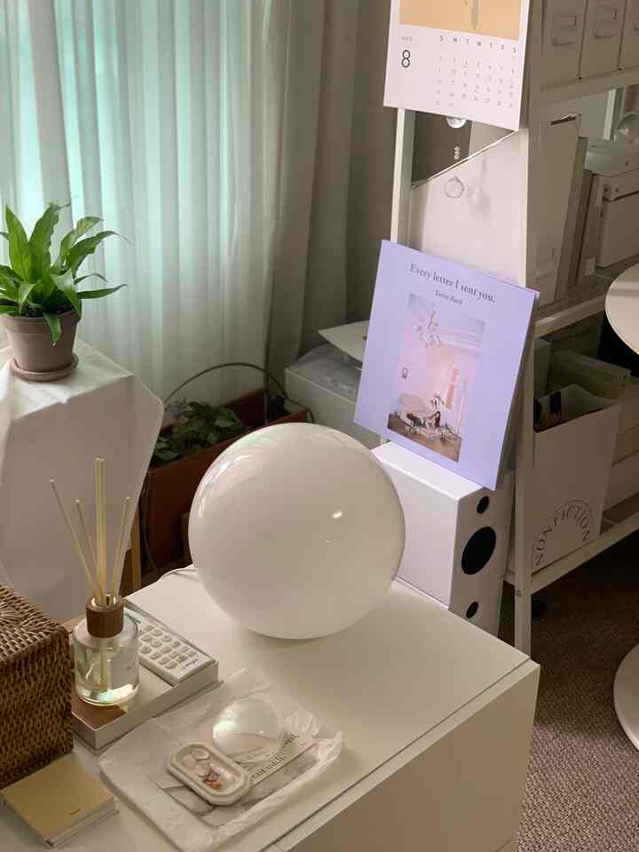 White and natural tone living room featuring LED mood lighting and plants in a simple modern interior