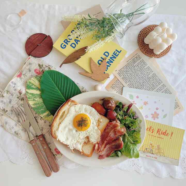 Natural home cafe scene with wood-tone accessories and brunch plate on a white table