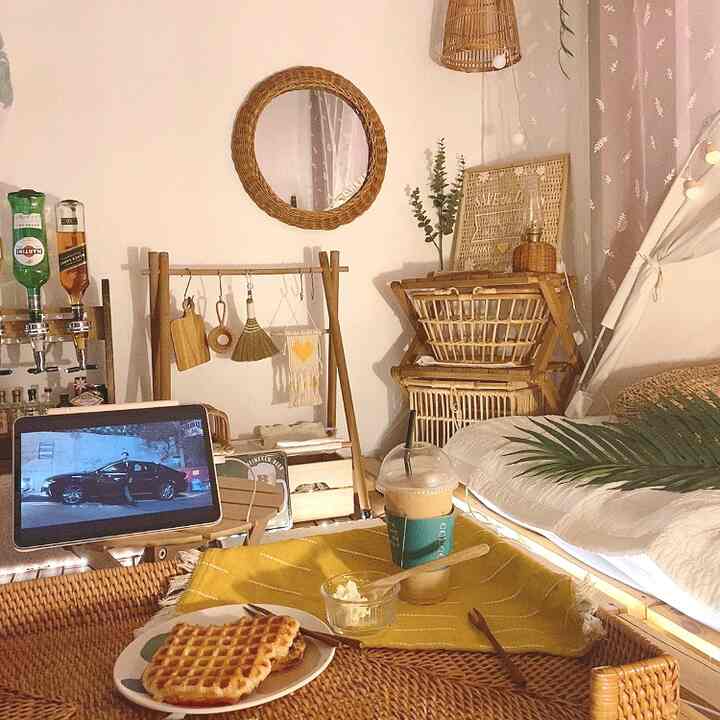 Cozy living room with natural tones featuring wooden and rattan furniture and home cafe elements