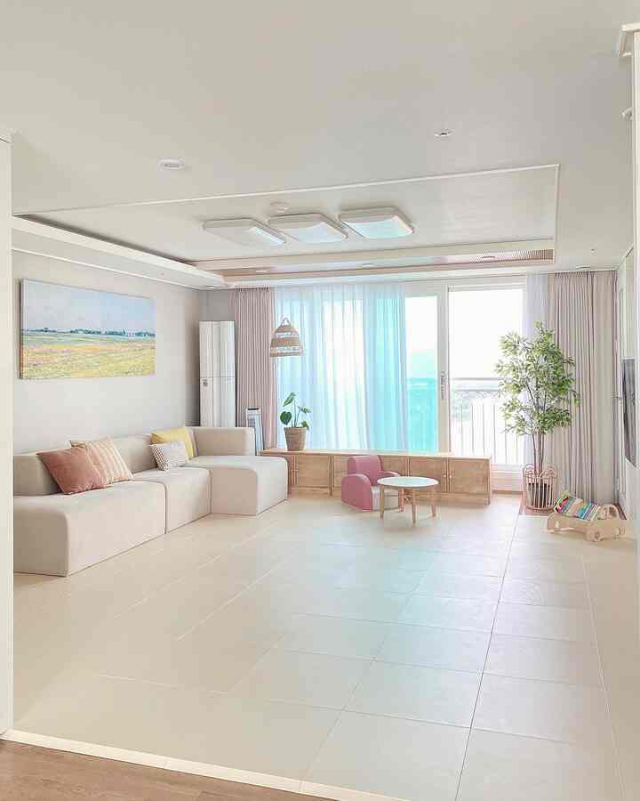 Beige and wood-toned living room featuring children's furniture and sofa with a natural and cozy atmosphere