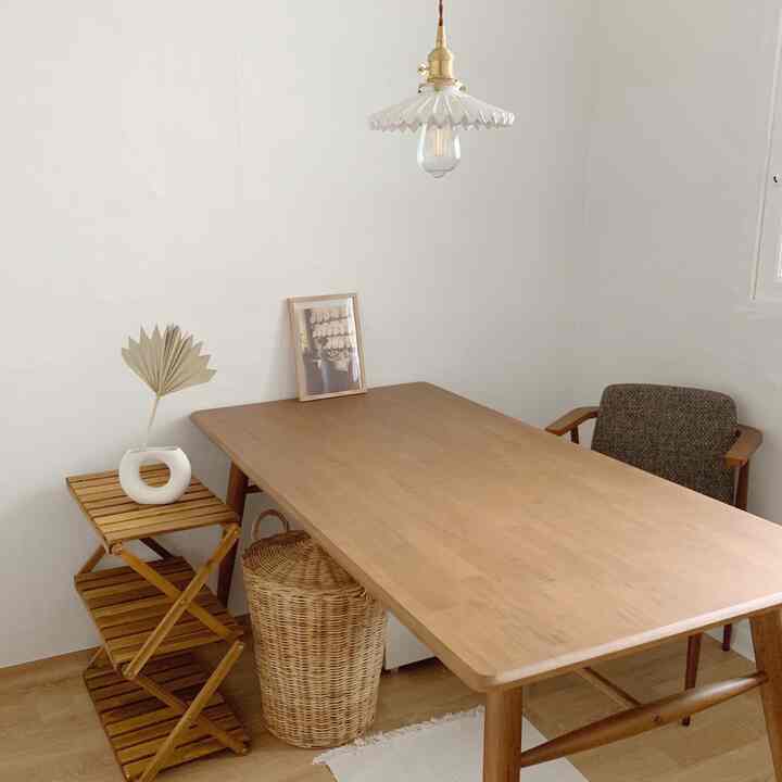 Bright white walls and a wood-tone dining table create a natural style dining room space