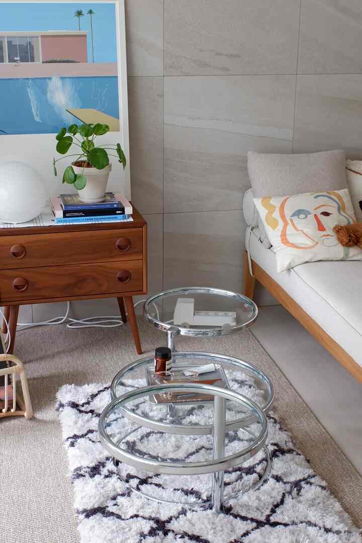 Natural toned living room featuring a wooden nightstand and ivory sofa with a cozy atmosphere
