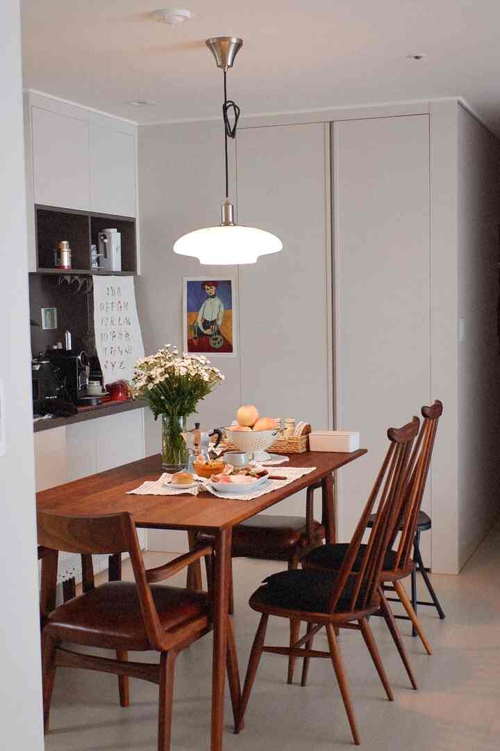 Bright and simple dining room featuring natural brown wooden dining table and chairs