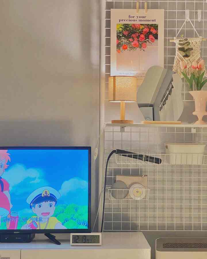 Simple and white-toned living room featuring a vanity mirror and table lamp with a neat and cozy atmosphere