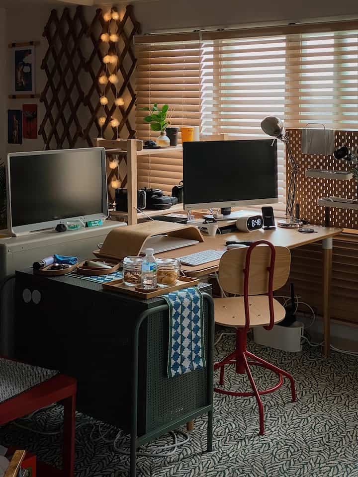 Wood tone and bright blinds in a home office featuring monitors and desk, creating a warm workspace atmosphere