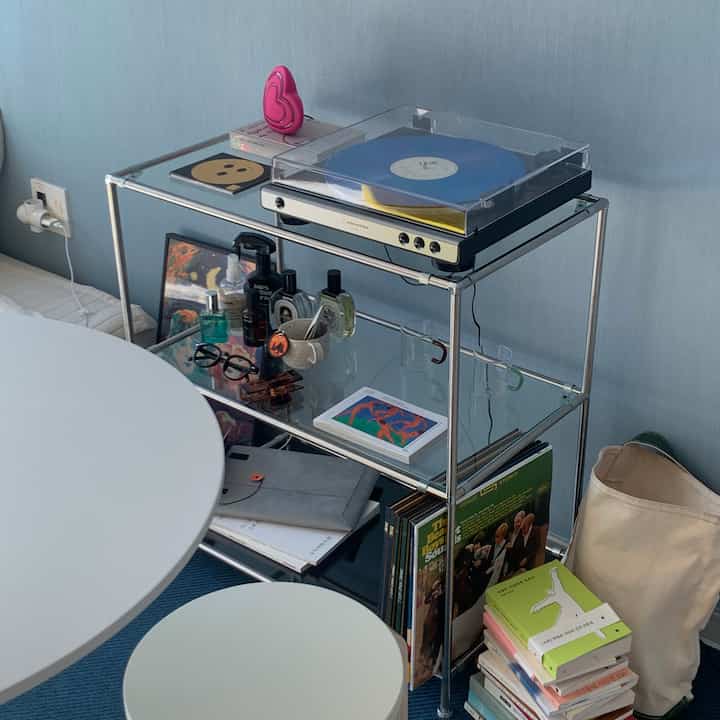 Cozy space with blue walls and silver modular shelf featuring Audio-Technica turntable and LPs