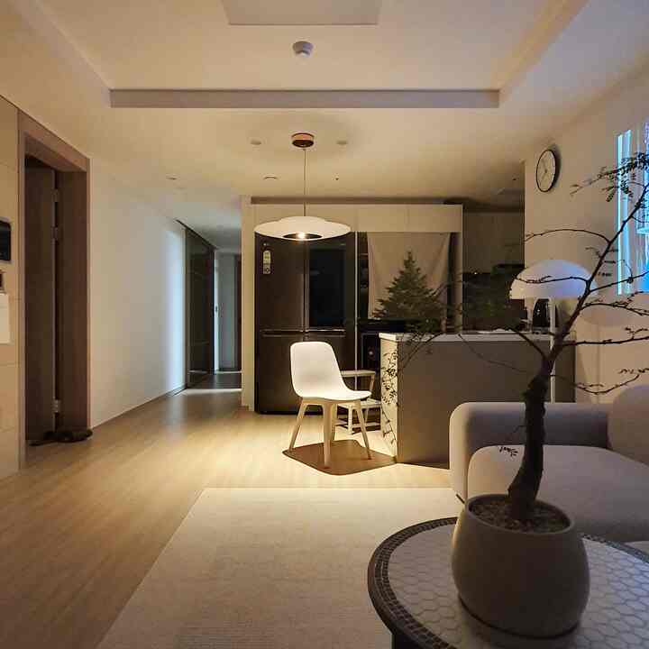 White and wood tone living room and kitchen featuring simple and natural style atmosphere