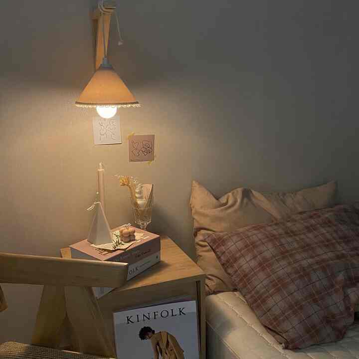 Natural beige and wood tone bedroom featuring a nightstand with warm lighting creating a cozy atmosphere
