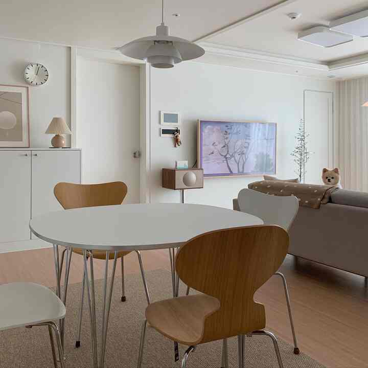 White and brown toned living room featuring dining table and chairs with a cozy natural atmosphere