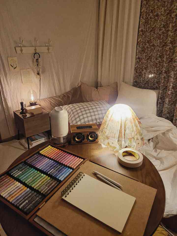 Warm beige-toned small bedroom featuring wood nightstand and vintage decor creating cozy atmosphere