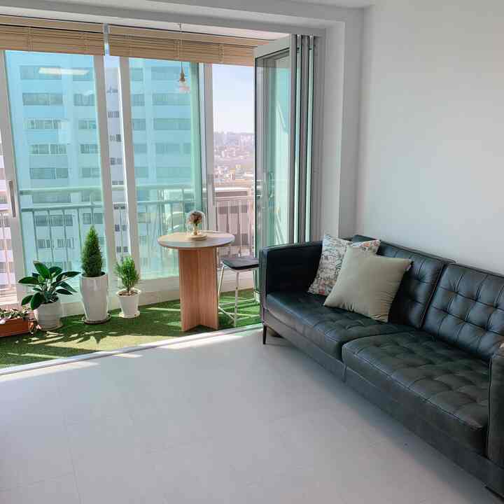 Wood tone and green dominated living room with folding door, simple and natural ambiance