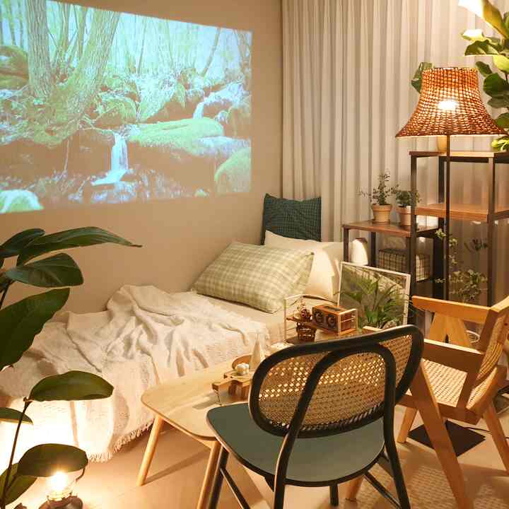 Cozy bedroom with natural wood tones and green plants, featuring a low table and rattan furniture enhancing a relaxing atmosphere