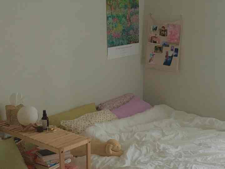 Soft beige and lavender toned bedroom featuring pillows, duvet cover, and natural modern decor creating a cozy atmosphere