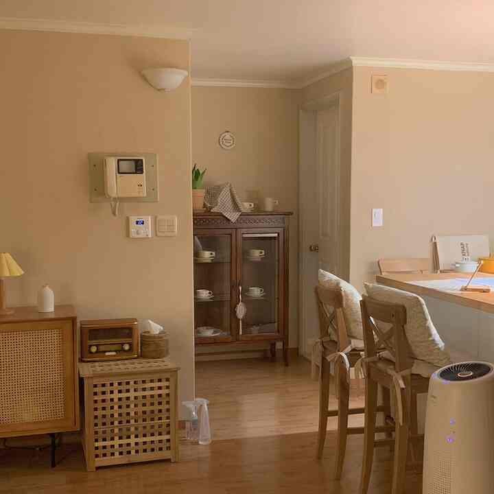 Cozy kitchen and living space featuring beige walls and wood-toned furniture with warm natural atmosphere