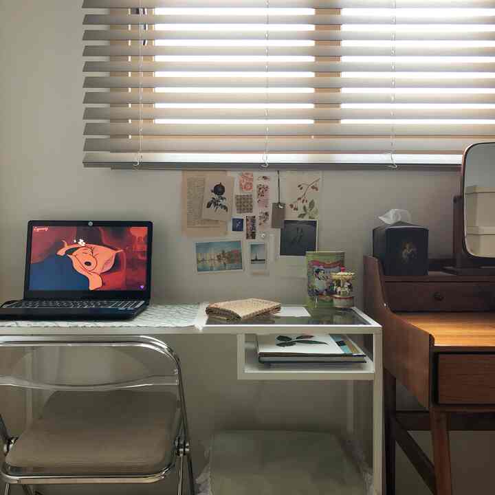 White and brown toned personal room featuring a desk and vintage vanity with a cozy home office atmosphere