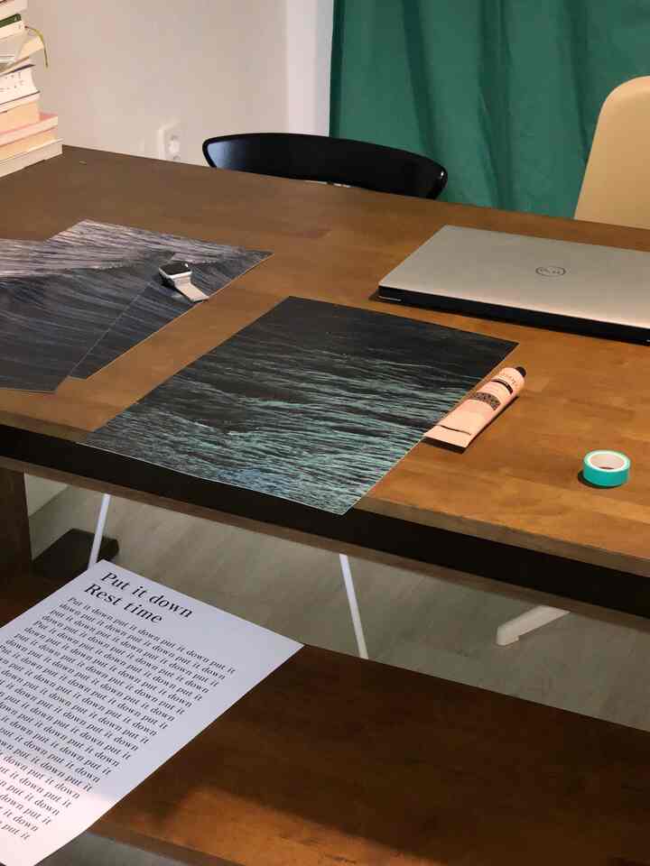 Warm wood-tone study featuring a wooden table and chairs with posters laid out on the cozy workspace