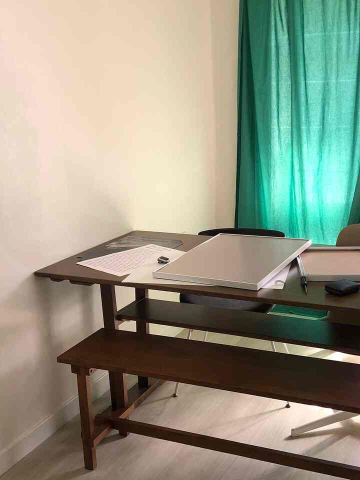Dining room with natural colors featuring wooden furniture and green curtains, creating a cozy atmosphere