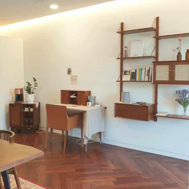 Antique-style study space featuring warm brown wooden furniture and herringbone floor pattern