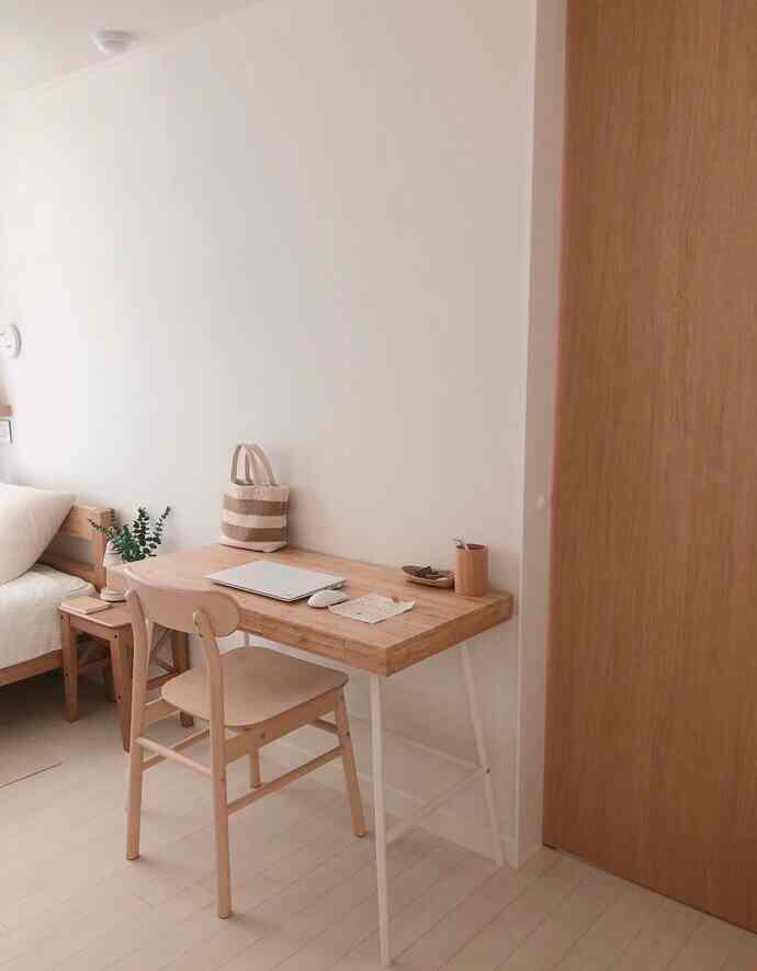 Natural wood tone and white colored bedroom home office space designed for a single household