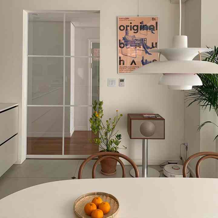 Natural toned dining room featuring wood tone chairs and plants with a cozy atmosphere