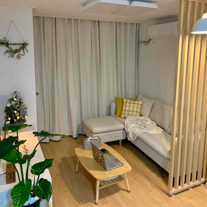 Cozy living room in beige and wood tones featuring beige sofa and wooden coffee table in a natural modern style