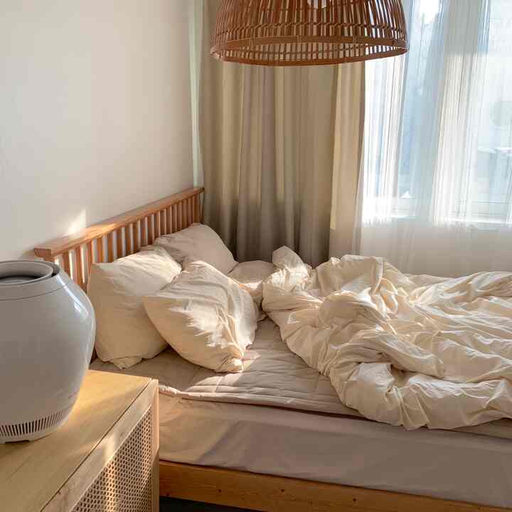 Beige and wood tone bedroom featuring a bed and rattan pendant lighting with a warm, cozy atmosphere