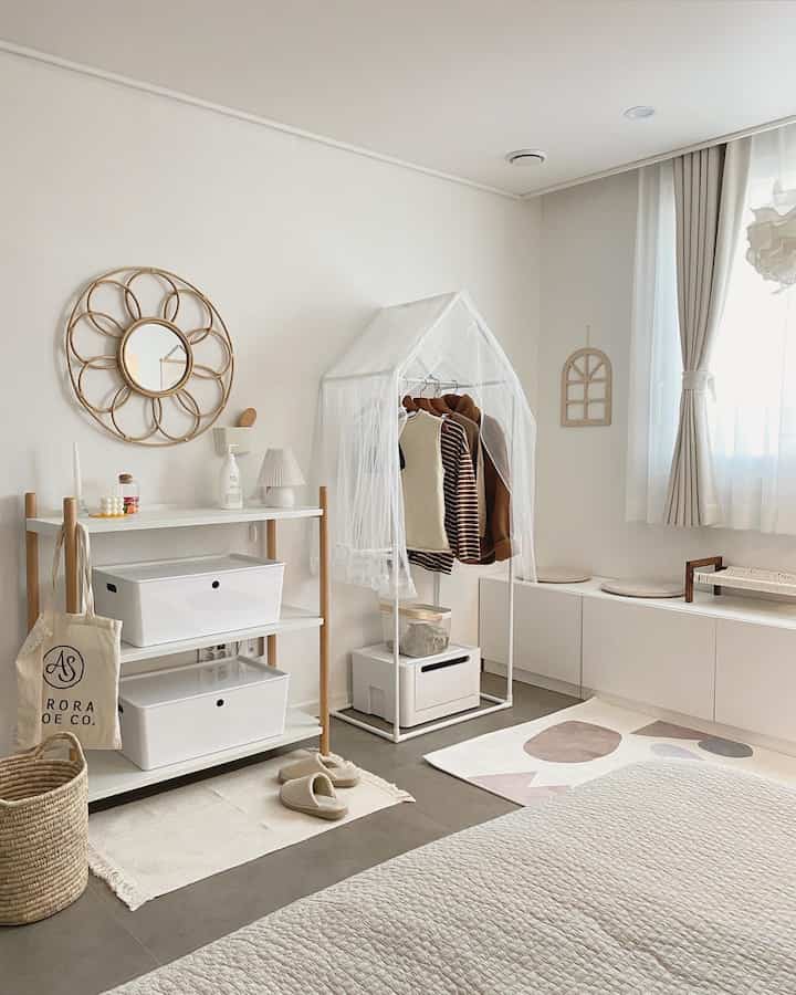 White and wood tone kids' room featuring clothing storage, natural organization, and a warm atmosphere