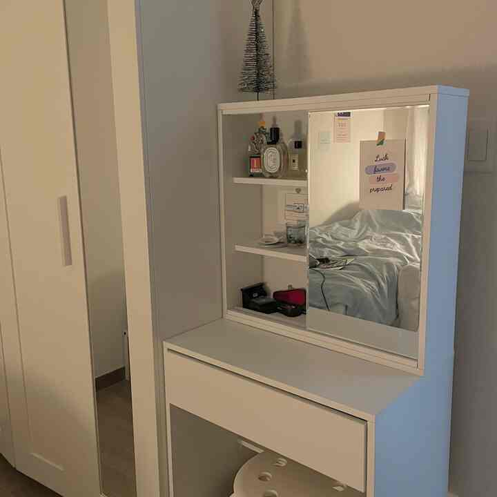 White-toned bedroom vanity with mirror, simple and clean storage-focused space