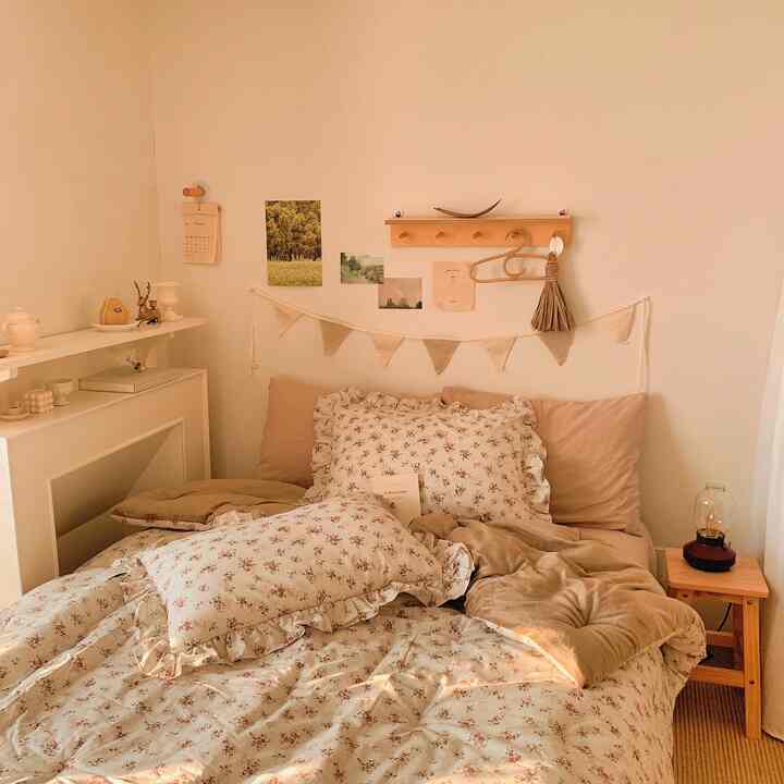 Beige-toned bedroom featuring floral bedding and wooden side table with a cozy, natural atmosphere