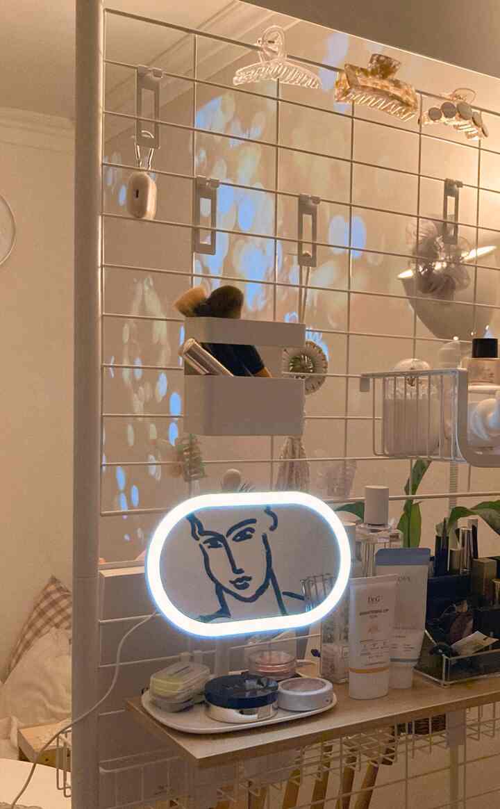White-toned powder room featuring a LED mirror and Henri Matisse-style poster with minimalistic interior design