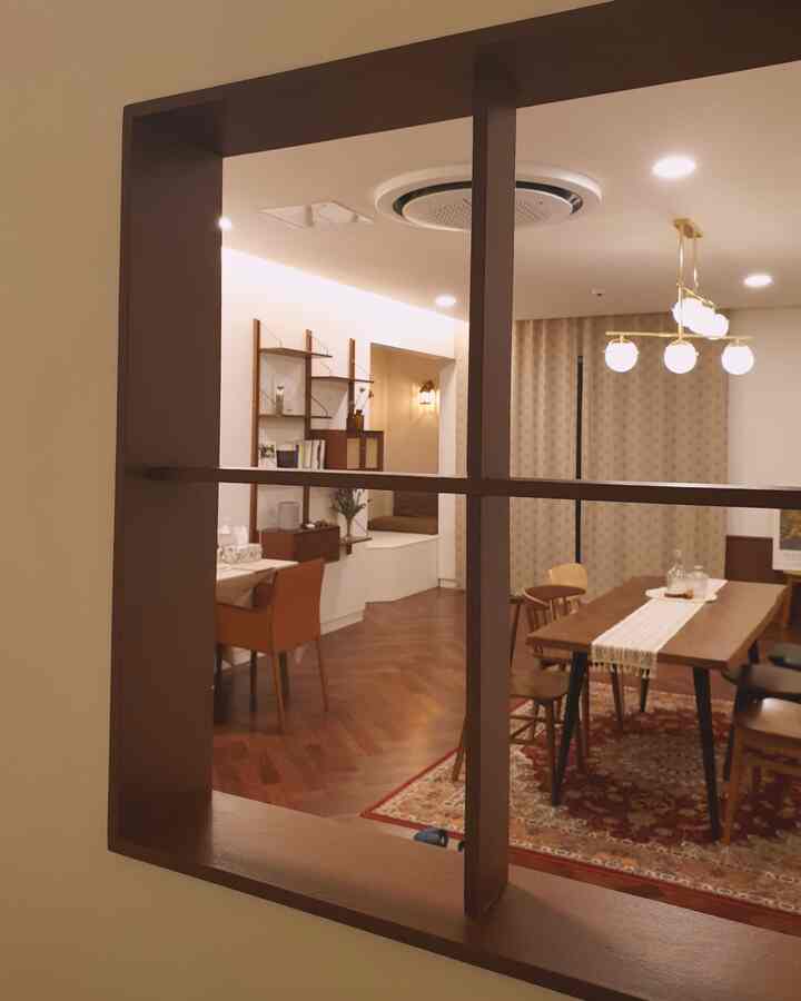 Warm wood tones and beige dining room featuring a vintage rug and pendant lighting, creating a cozy atmosphere