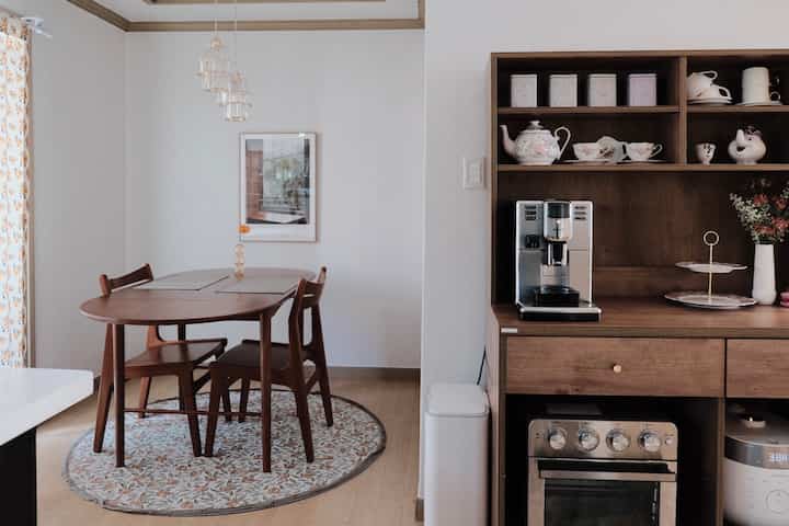 Cozy dining room with white walls and warm brown wood-toned dining table and furniture