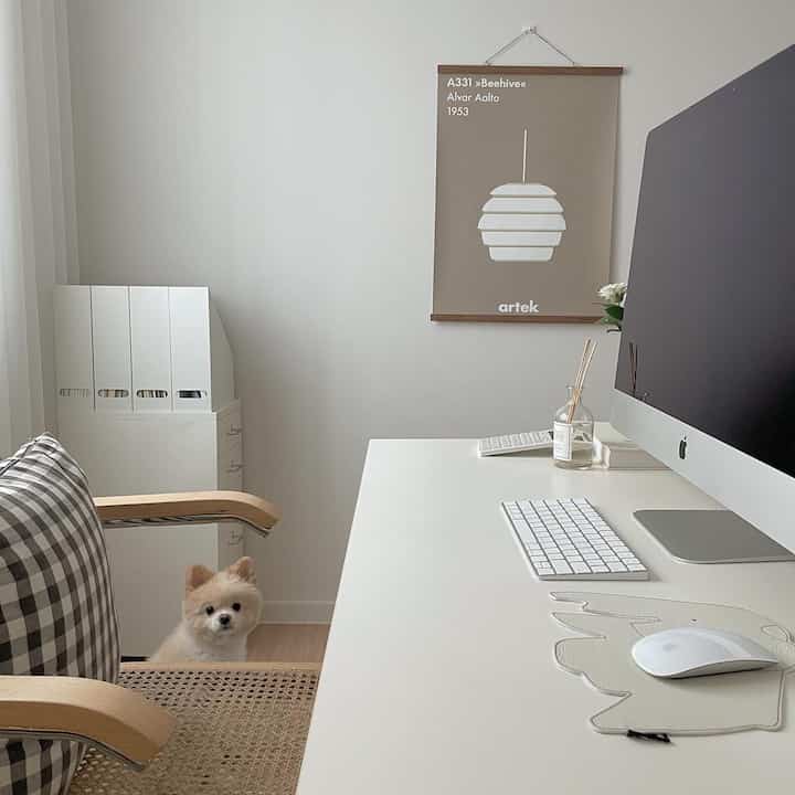 White and natural toned study featuring a white desk, iMac, and neat, well-lit home office space